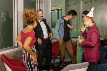 Business workers from different ethnicities celebrate a great achievement after long effort. Business people and members of LGBT work together and enjoy big success in a party