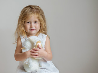 Redhair girl with snowman and angel on light gray background 