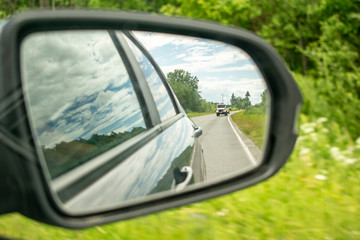 Reflection of the road in the car mirror.