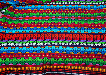 Traditional mayan textile pattern with bright colors and figurines, Antigua Guatemala