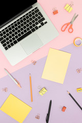 Top view of laptop and cute office supplies on a colorful background. Back to school concept.