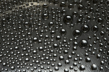 Black metal spheres are located on a mirror ice surface. Space abstraction. 