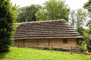 Old authentic wooden house with a thatched roof