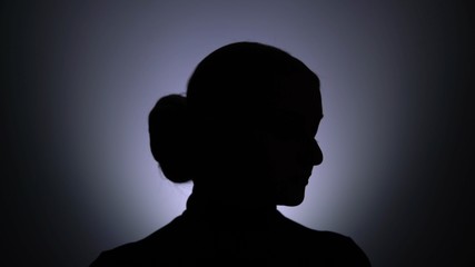 Silhouette of woman posing at the camera