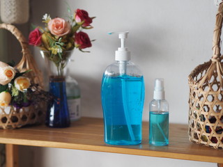 Hand Sanitizer, gel alcoholic mixture with gelatin in clear Plastic bottle with pump pushing wash clean dirty to prevent germs protect Contagious disease corona virus, covid-19 on wooden shelf