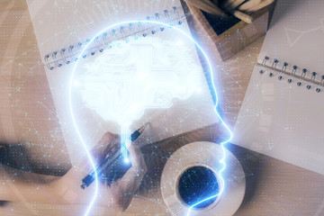 Multi exposure of woman's writing hand on background with brain hologram. Concept of brainstorming.