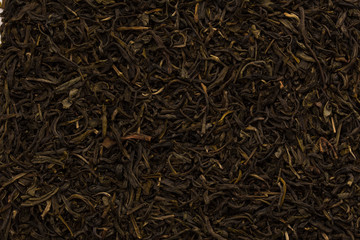Filled abstract background of tea leaves. Black, green tea