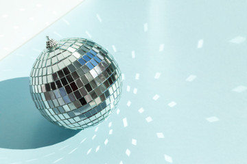 Shining disco ball on blue background. Disco ball with bright rays