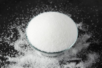 A glass bowl with white sugar
