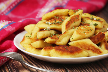 Polish dish kopytka served at the table