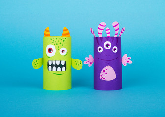 colorful monsters made out of toilet paper on a blue background