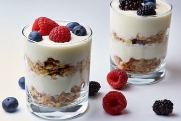 Glasses of yogurt and muesli with fresh fruit