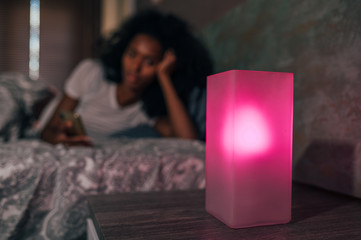 Smart lamp near reading woman