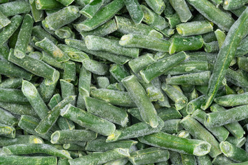 Frozen chopped green string beans texture background. iced beans background for food textures. Uncooked vegetable.