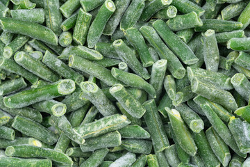 Frozen chopped green string beans texture background. iced beans background for food textures. Uncooked vegetable.