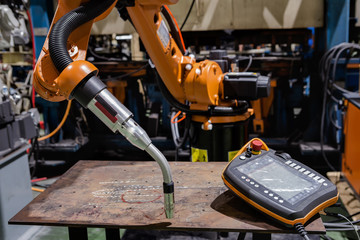 Robots welding team in the automotive parts industry