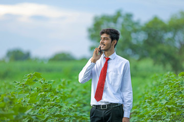 Young indian man talking on mobile phone