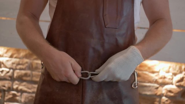 Butcher in a Leather Apron with Tool Chain. High quality 4k footage