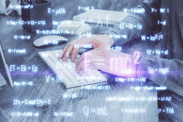 Science formula hologram with man working on computer on background. Education concept. Double...