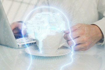 Man with computer background with brain theme hologram. Concept of brainstorm. Double exposure.