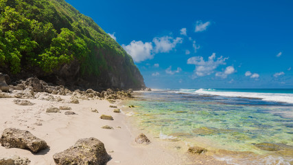 Fototapeta na wymiar Tropical wild beach in Bali. Sandy beach and ocean
