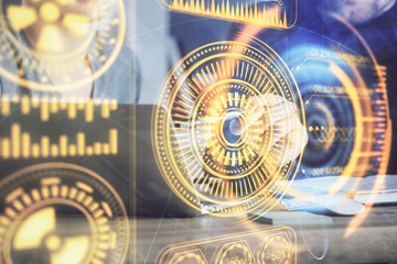 Technology theme hologram with man working on computer on background. High tech concept. Multi exposure.