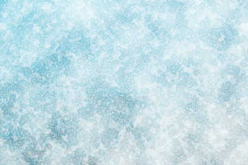 The surface of the earth is covered with snow. Frost texture iced surface - Winter material. Texture of ice. Snow texture. Cracked ice background. Abstract frozen water.Ice texture winter background.