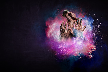 Hand holding up a gold trophy cup against dark background