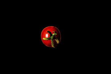 cherry tomato on a black background