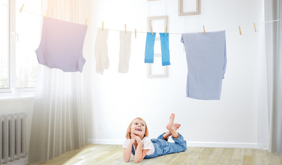 Happy little girl with washed clothes