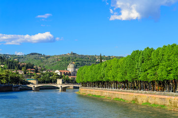 Fototapeta premium Verona Embankment of the Adige River view of the Garibaldi Bridge and Campanile San Giorgio in Braida. Italy