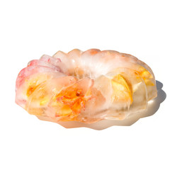 Frozen flowers trapped in a block of ice of shape cake. Roses in ice.