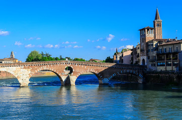 Fototapeta na wymiar Bridge Pietra ( Ponte Pietra ). First finished in 100 BCE, this scenic Roman arch bridge was rebuilt after being destroyed in WWII. Verona, Italy