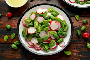 Cucamelon radish salad on rustic wooden table. healthy summer food