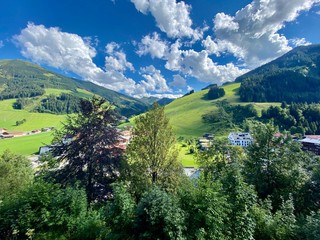 View of Hinterglemm village and mountains in Saalbach-Hinterglemm skiing region in Austria on a beautiful summer day.