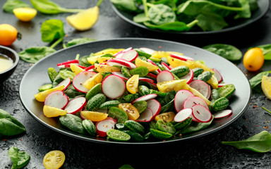 Cucamelon salad with radish, tomato, spinach and mustard dressing. Healthy food.