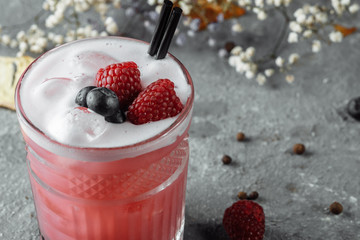 Smoothie made from frozen raspberries, blueberries. Cocktail with blueberries and raspberries on a decorative background