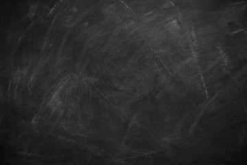 Abstract texture of chalk rubbed out on blackboard or chalkboard background. School education, dark wall backdrop or learning concept.