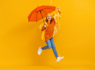 Kid with umbrella on colored background.