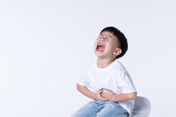 Asian boy touching his belly from stomach pain symptom