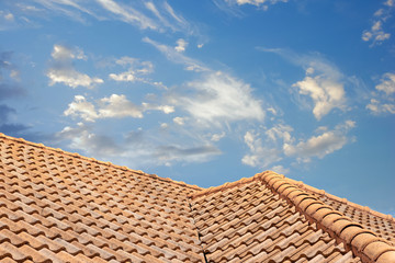 Close up of brown clay roof tiles. Red old dirty roof. Old roof tiles. Construction equipment build a house.