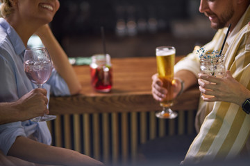 delicious cocktail in hands, close-up. at bar. nightime in the club