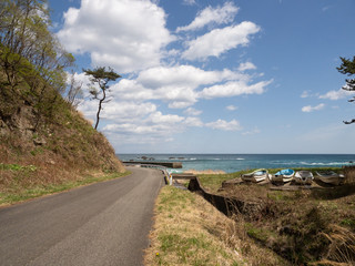A view of the trail along the ocean with blue sky. The Michinoku Coastal Trail in Iwate Prefecture, Japan.