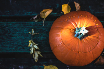 Orange pumpkin on a wooden background on Halloween.
