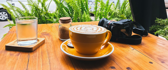 Cup of hot cappuccino coffee with latte art.