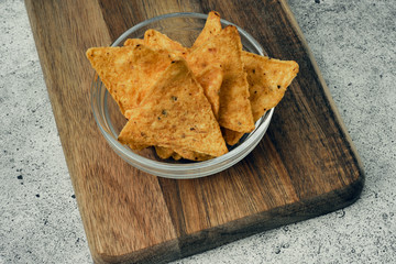 Corn cheese, snacks with sauce on a wooden stand. Beer snack, dish on the menu. Close up.