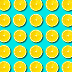 Top view of cut slice ripe lemon pattern on blue background
