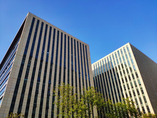 two high buildings under the blue sky in sunny day