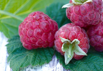 Raspberry. Red raspberries on a wooden table close-up. Raspberry berry texture. Fruit background....