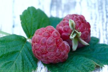 Raspberry. Red raspberries on a wooden table close-up. Raspberry berry texture. Fruit background. Horizontal, cropped, nobody, free space. Agriculture and healthy food concept.